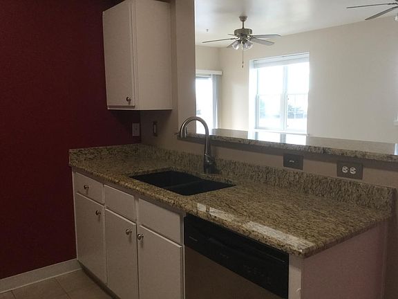 The "sink" side of the kitchen with breakfast bar.