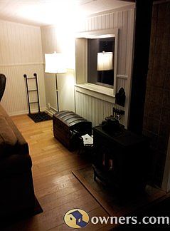 Woodstove in great room with ladder to basementW