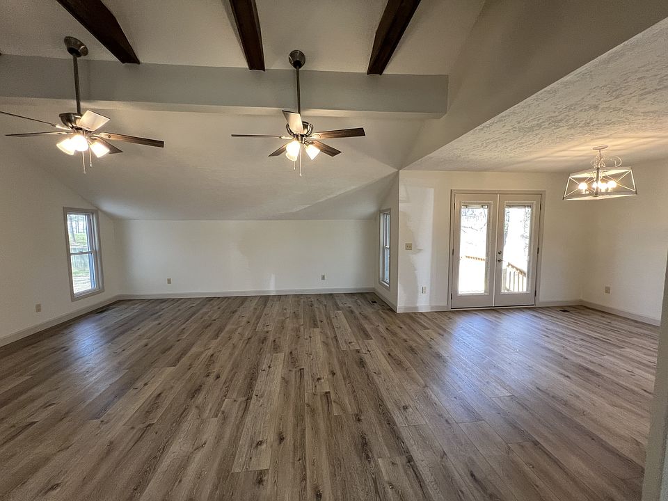Livingroom and Dining room with vaulted ceilings. Patio just outside the french doors