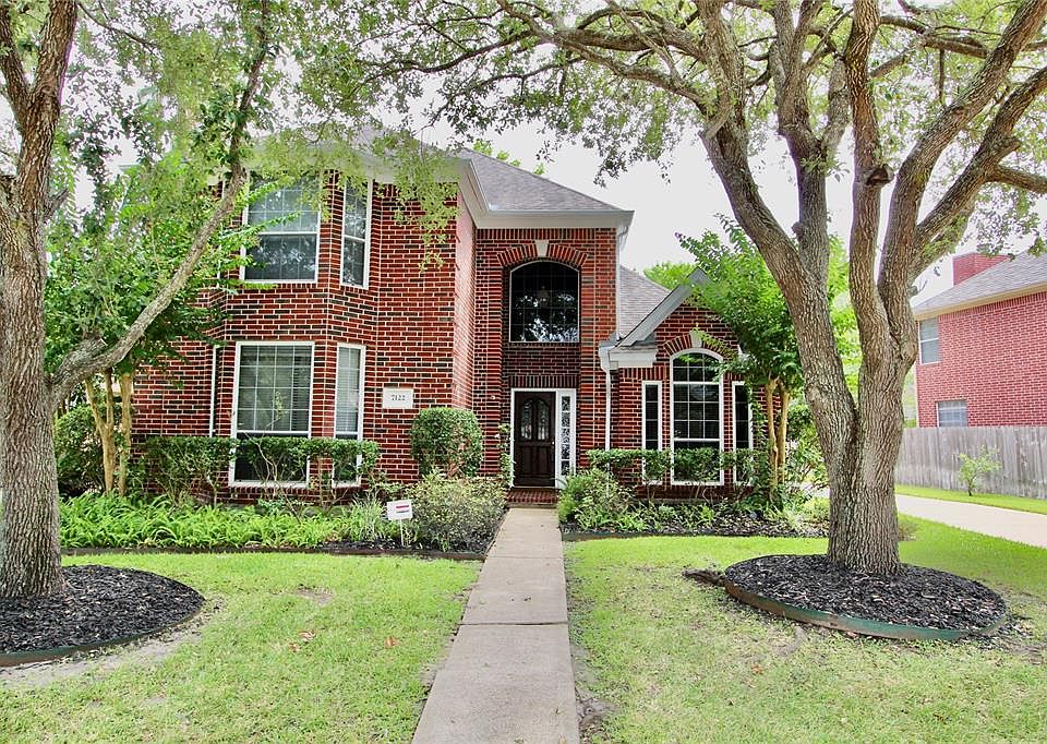 Beautiful 2-story home nestled in the heart of Greatwood with attractive red brick elevation, gabled roof and prominent bay windows. The front yard offers mature tress and shrubs.