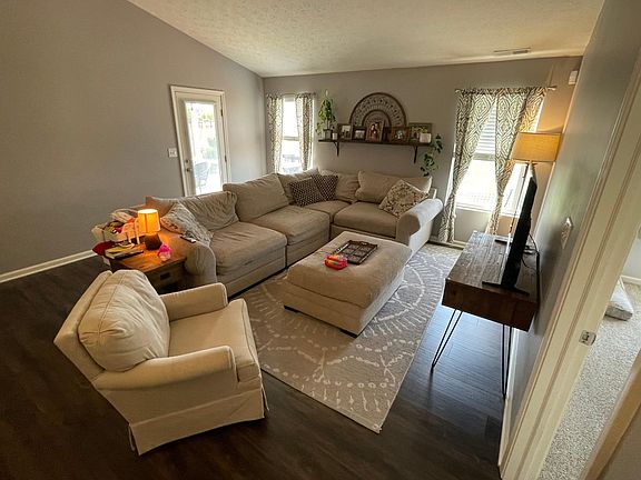 Open concept living room, big enough for a large sectional next to the dining area.