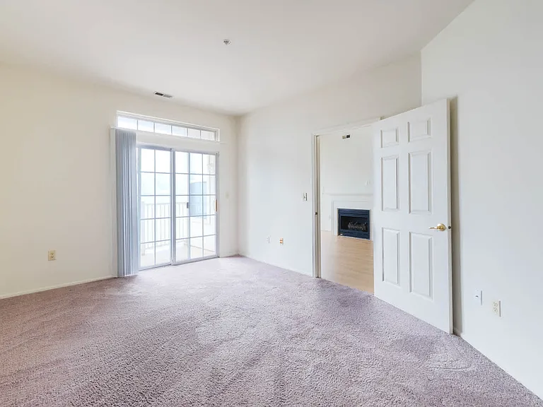 Carpeted Bedroom with Balcony