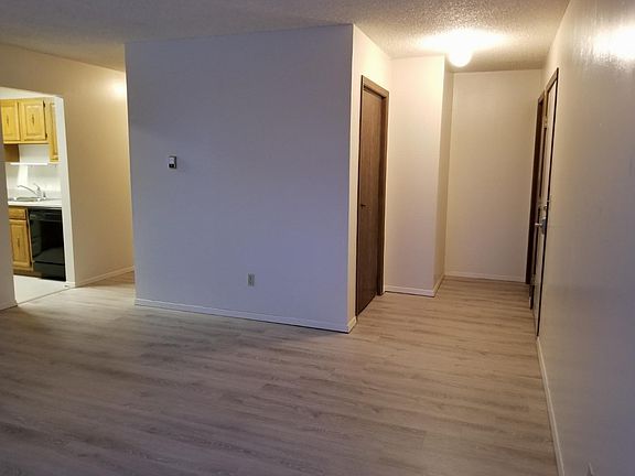 living room space, coat closet, front door and hallway