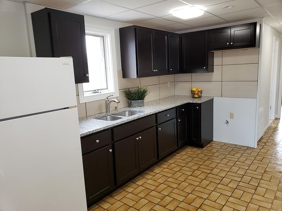 New cabinets and granite counters with backsplash