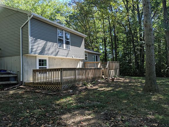 Exterior rear; deck; fenced yard; treed yard