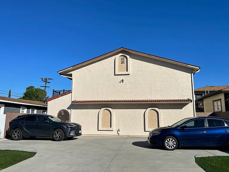 Front of 8 unit complex with security gate and one space, off street parking.