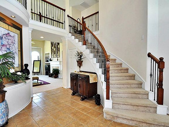 Tile floors in foyer, wrought iron spindles, spiral stairs, & a butler's pantry.