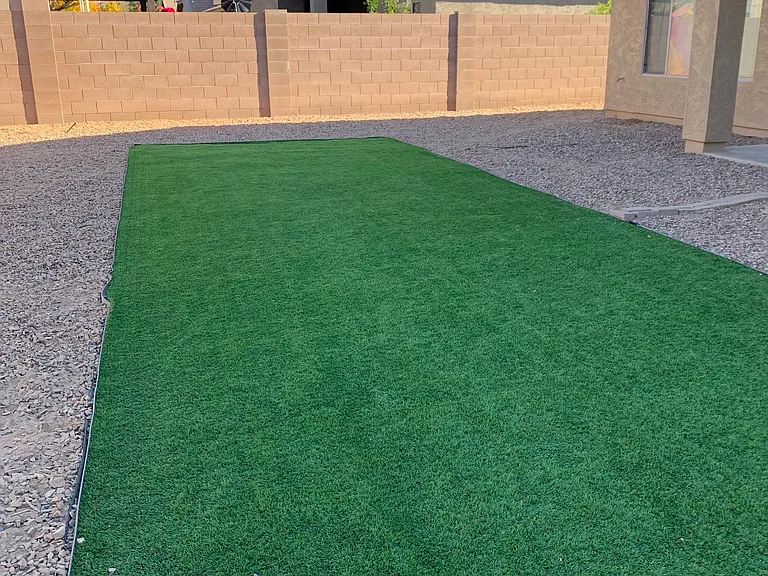 Finished backyard with gravel and artificial grass . No maintenance!