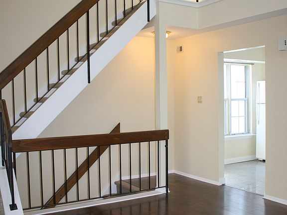 Living room with vaulted ceiling and stairs to the loft