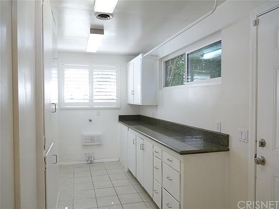 Laundry Room and Pantry Off Kitchen Has a Door To Side Yard