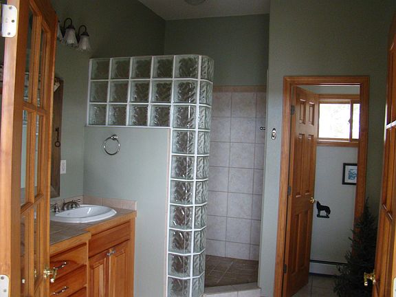 French doors to master bath. Double sinks with plenty of free space in the middle. Barn door mirror. Large walk-in closet directly behind vanity.