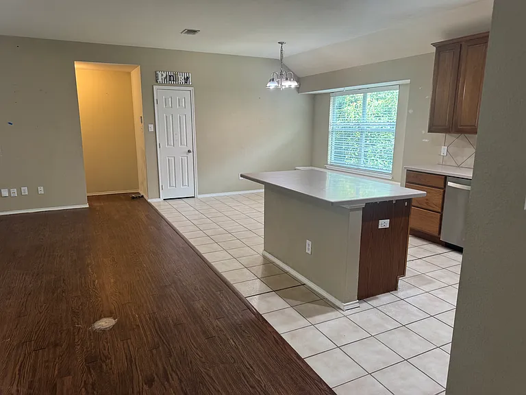 kitchen showing back hall that leads to the garage , utility room, and the master bedroom