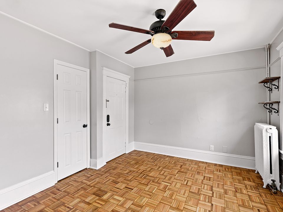 Large and sunlight filled living room with coat closet and under stairs storage space