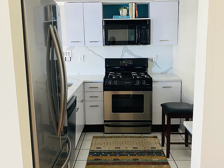 Kitchen entrance with new quartz counter and backsplash