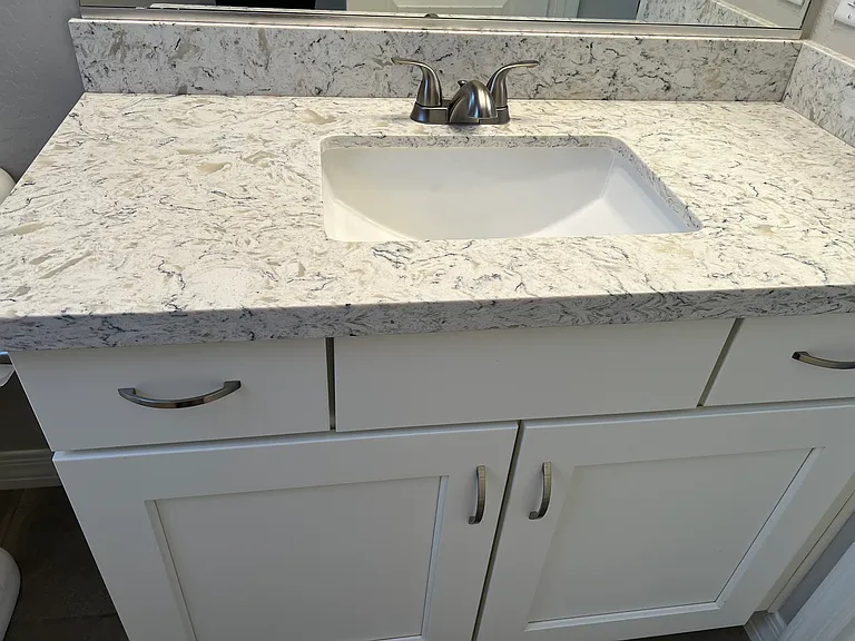 Quartz Countertop and White Cabinetry. Tile Floor