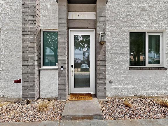 View of exterior entry with brick siding