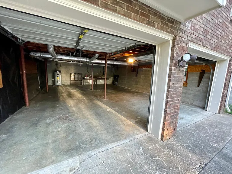 This is a photo of both garages with the doors open. Garages aren't particularly beautiful but you will see the massive size of these spaces. Each garage door has a garage door opener for your convenience.