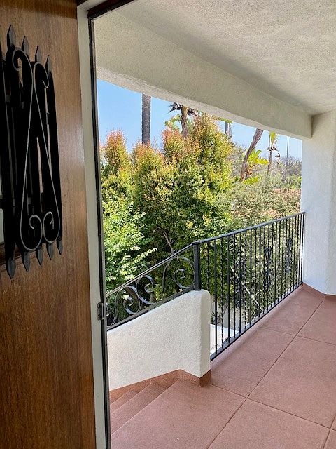 view looking out front door onto private balcony patio