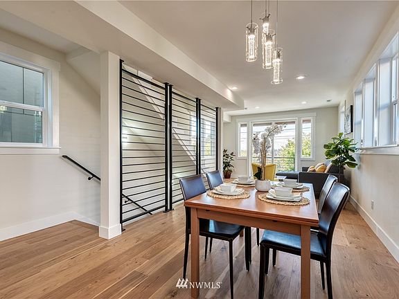 Welcome to this inviting open concept main floor with soaring 10 ft. ceiling, wide plank warm hardwood flooring, exquisite white millwork throughout and statement waterfall metal railing that adds a bold, modern and sleek touch.