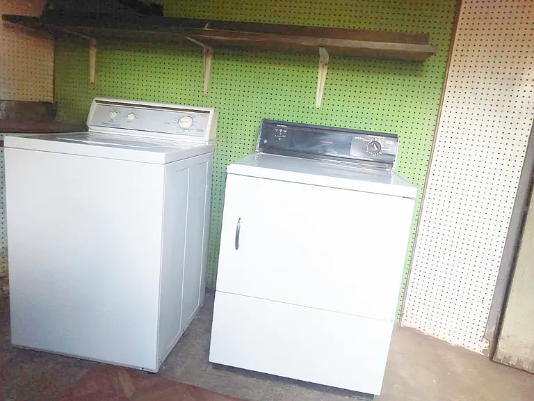 Laundry Room (located underneath the south corner of the house (partial unfinished basement) accessible by exterior door on rear patio.