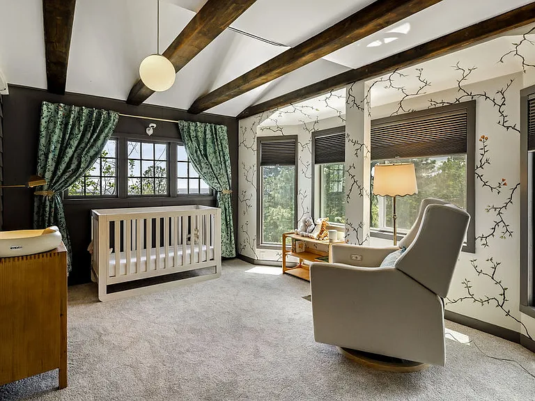 Bedroom #3 (set up as a nursery) with custom blackout curtains installed on large windows