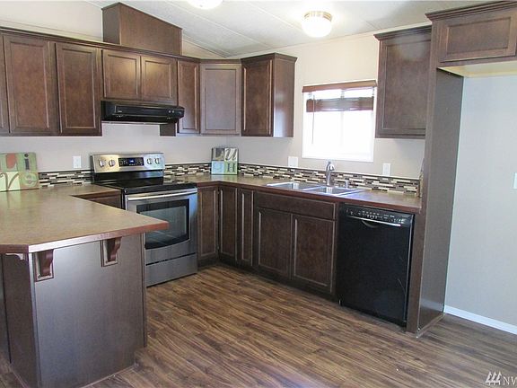 The kitchen features all new cabinets, counters and tiled backsplash.