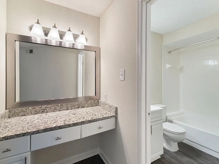 Bright bathrooms with large mirrors.
