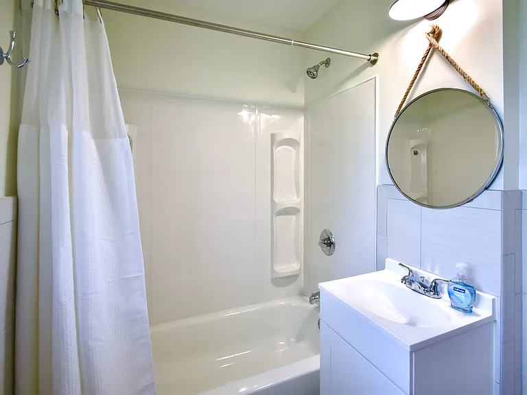 Newly remodeled bathroom with new vanity, tub, tile floor and