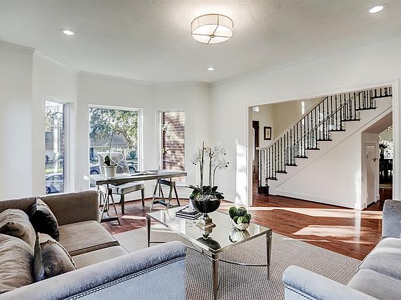 Another view of the formal living room showing dining room on the other side of the foyer.