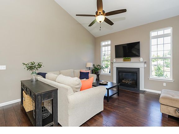 Great Room with Vaulted Ceilings, Gas Fireplace, Hardwood Flooring and Transom Windows