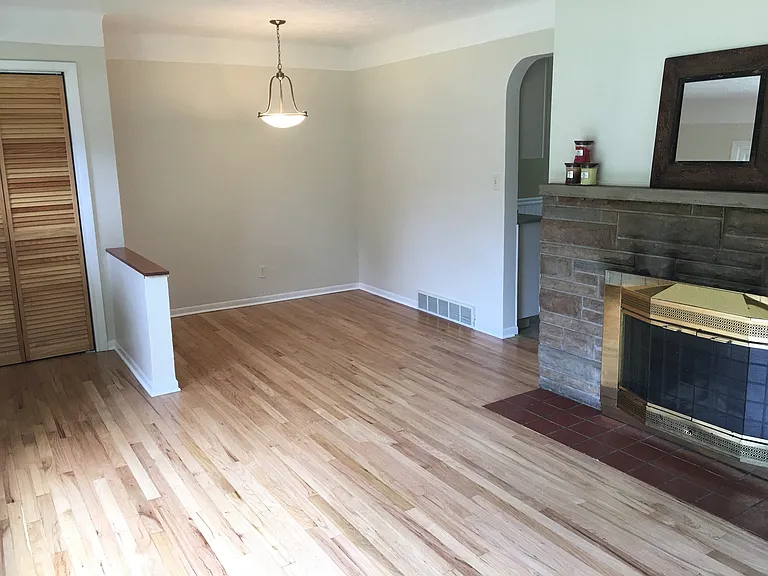 Dining room features refinished oak hardwood floors and updated chandelier.