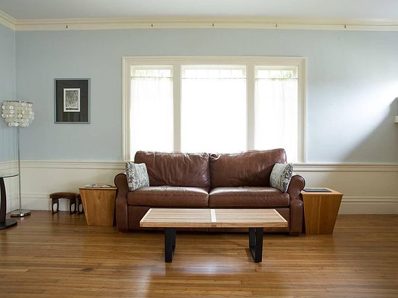 Living room looking toward street, home has high ceilings