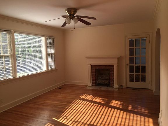 Living room with gas fireplace, real hardwood floors, crown