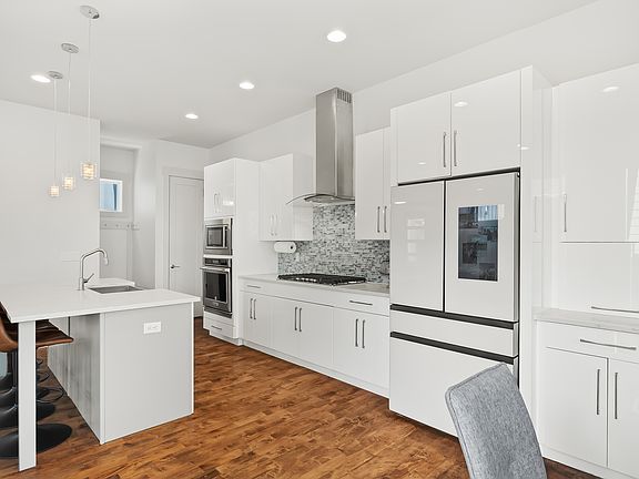 Smart refrigerator, contemporary cabinets and walk-in pantry