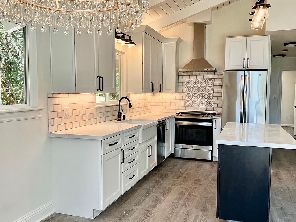 Other angle of kitchen and dining nook in foreground.