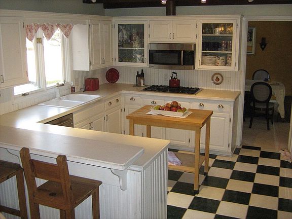 large kitchen with several stainless steel appliances