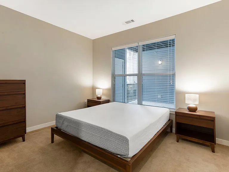 Furnished+ apartment homes feature queen bed with mattress, dresser, nightstands, and lamp (Representative Image exact items and style of furnishings may vary)