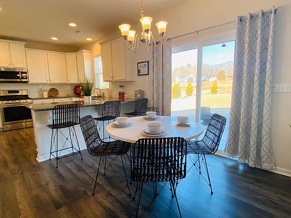 Kitchen eating nook with peninsula bar counter and large glass sliding doors leading to the backyard.