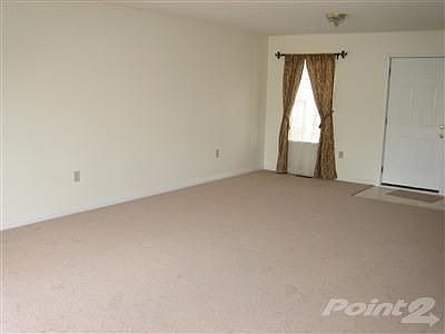 Living room with <b>new carpet</b> and freshly painted walls.