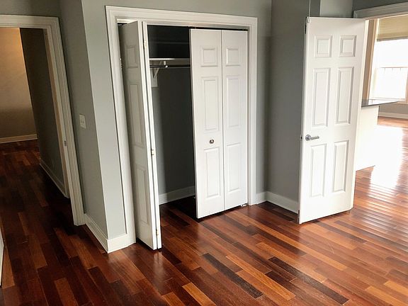 1st room that can easily be a guest bedroom or an office. With doors leading to the living room and hallway to 2nd bedroom.