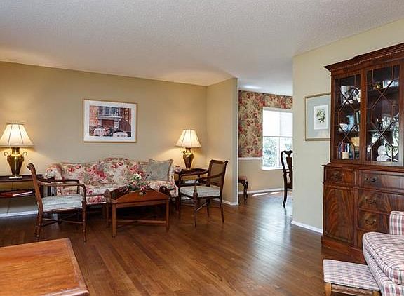 View from the front door through the formal living room into dining room. Beautiful hardwood floors and window seat to the left not visible in picture