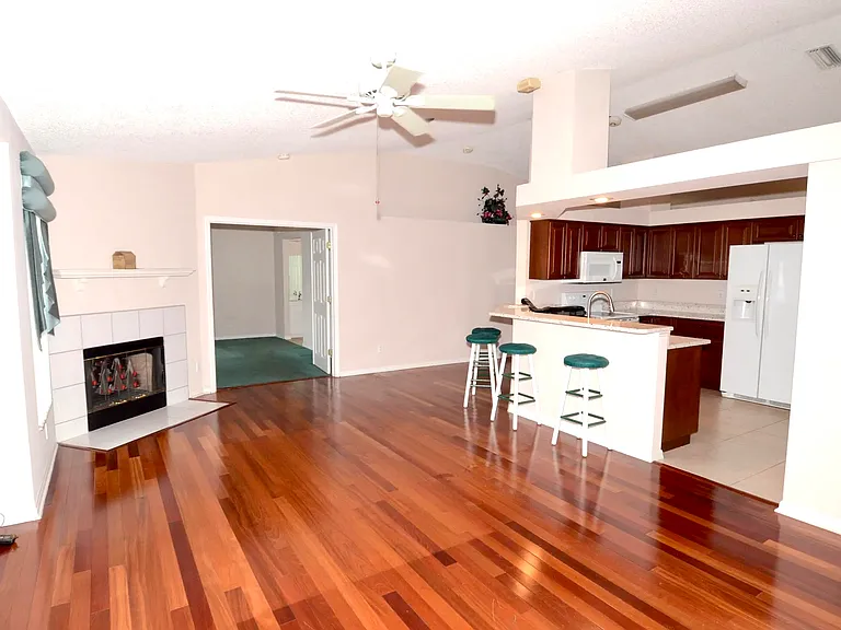 Family room with working fireplace, open to kitchen