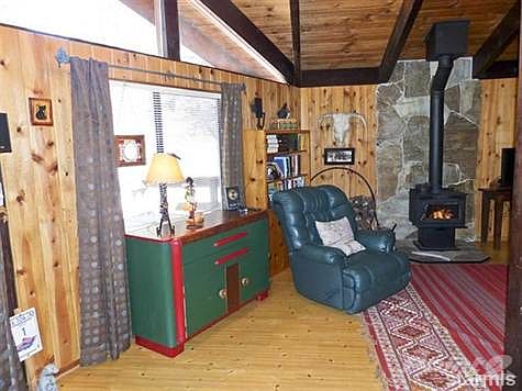 Living Room with Knotty Pine Walls and Laminate Floors