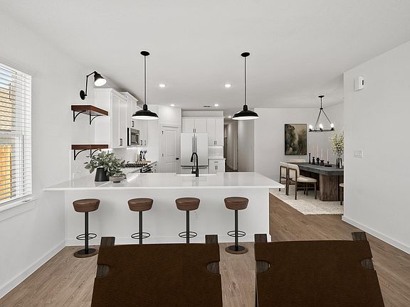 Kitchen with pendant lighting and floating shelves