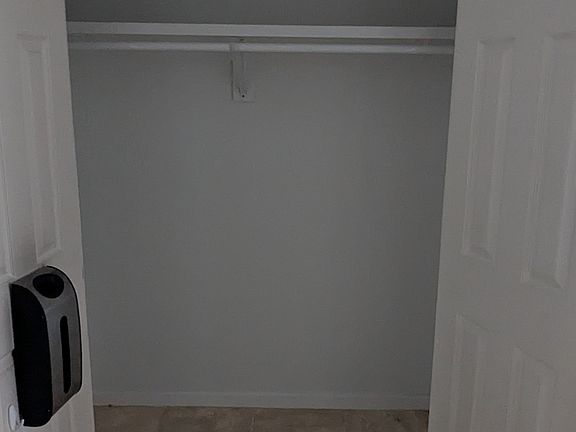 Newly built foyer closet with grocery bag storage container