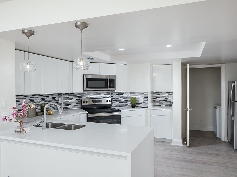 Modern kitchen with stainless steel appliances, granite countertops and designer cabinets