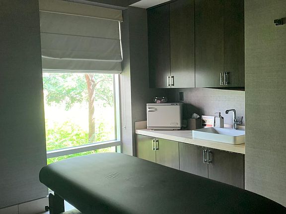 Typical rentable booth setting for body message or facial treatment room. Come with host towel machine, bed, sink and storage cabinet space.