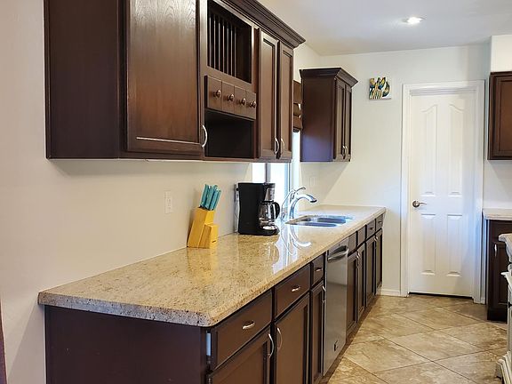Plenty of countertop and cabinet space with walk in pantry