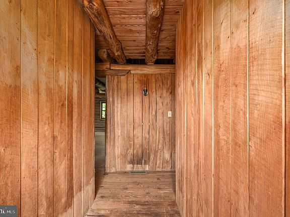 hall to left of entry leads to bedroom and kitchen