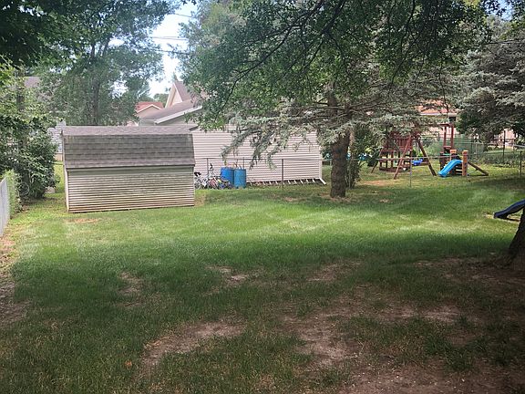 Fenced in backyard with shed